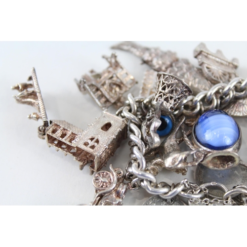 212 - Silver charm bracelet including souvenir charms (127g)