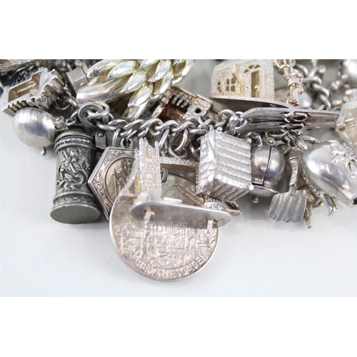 217 - Silver charm bracelet including souvenir charms (153g)