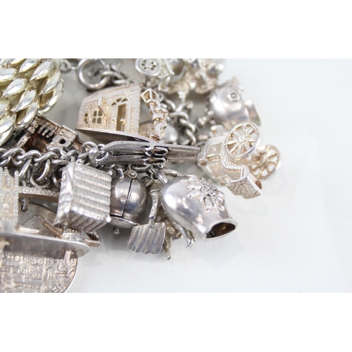 217 - Silver charm bracelet including souvenir charms (153g)