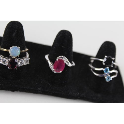 246 - A collection of silver gemstone rings including Opal (24g)