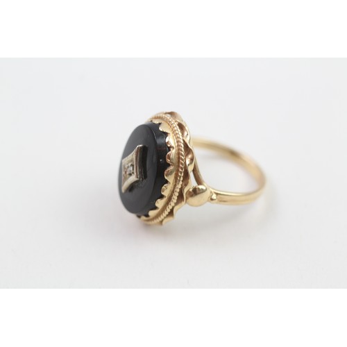 103 - 9ct gold diamond & black onyx dress ring with a decorative setting & English hallmarks (5.3g) Size  ... 