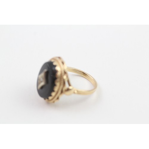 103 - 9ct gold diamond & black onyx dress ring with a decorative setting & English hallmarks (5.3g) Size  ... 