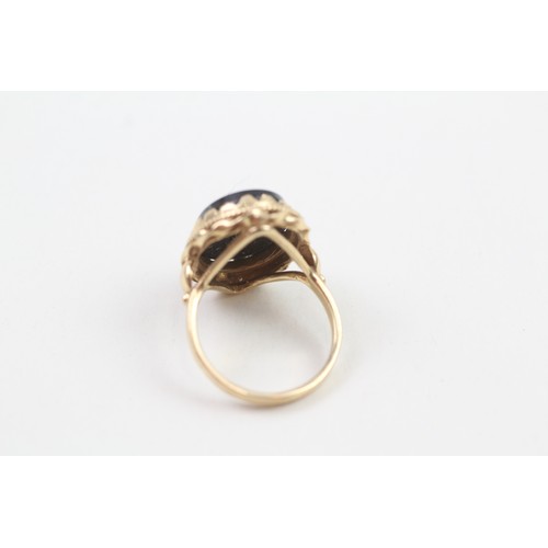 103 - 9ct gold diamond & black onyx dress ring with a decorative setting & English hallmarks (5.3g) Size  ... 