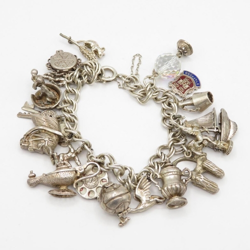 Fine silver charm bracelet with assorted charms, some articulated  65.8g  total weight