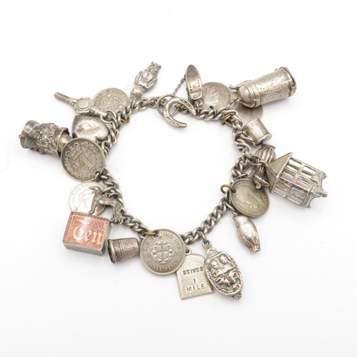 Fine silver charm bracelet with charms, some articulated.  64.8g
