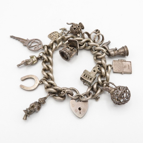 Chunky silver charm bracelet with assorted charms, some articulated  90g