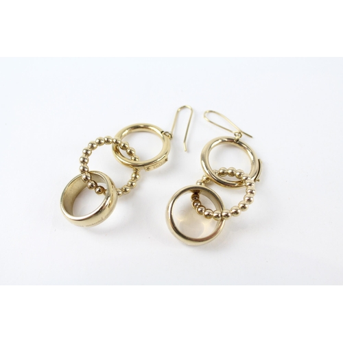 A pair of gold tone drop earrings by Dolce and Gabanna (g)