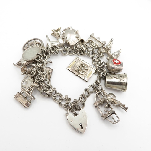 Silver charm bracelet with assortment of charms - some articulated   76g