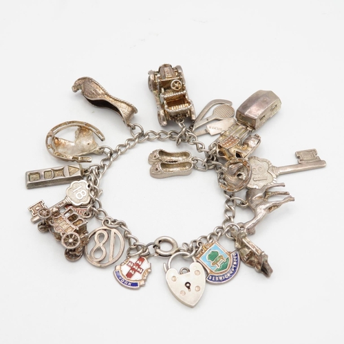 Silver charm bracelet with assorted charms - some articulated  64.1g