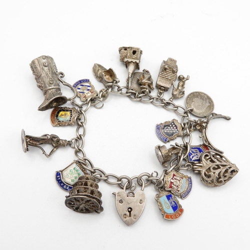Silver charm bracelet with assorted charms - place names and some articulated  59.3g