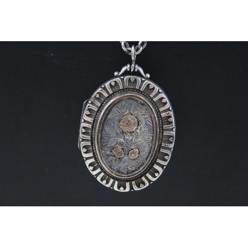 339 - A Victorian silver locket with gold detailing and chain (29g)