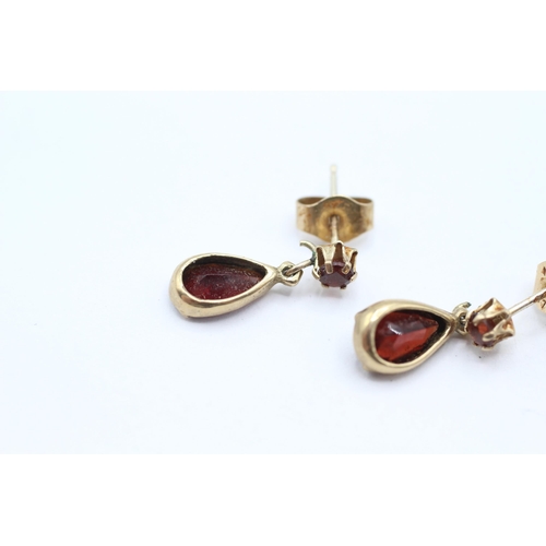 28 - 9ct gold pear cut garnet drop earrings with scroll backs   - 1.3 g