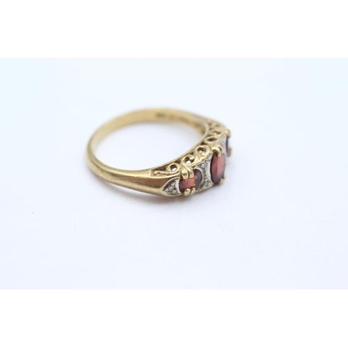 27 - 9ct gold garnet three stone with diamond accent Size  P   - 3.4 g