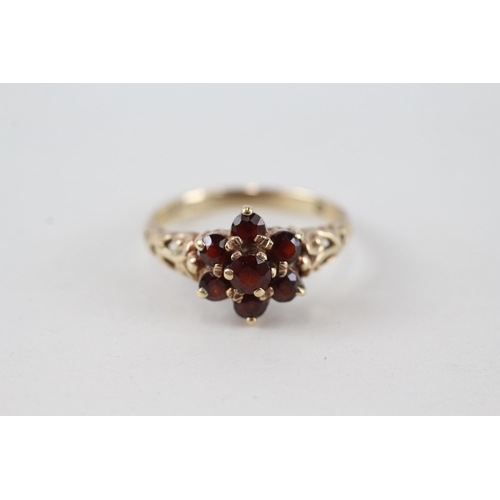 65 - 9ct gold garnet seven stone floral cluster ring (2.6g) Size  P