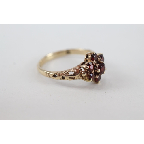 65 - 9ct gold garnet seven stone floral cluster ring (2.6g) Size  P