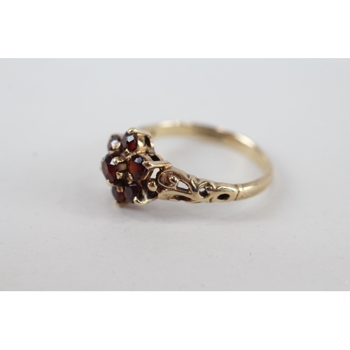 65 - 9ct gold garnet seven stone floral cluster ring (2.6g) Size  P