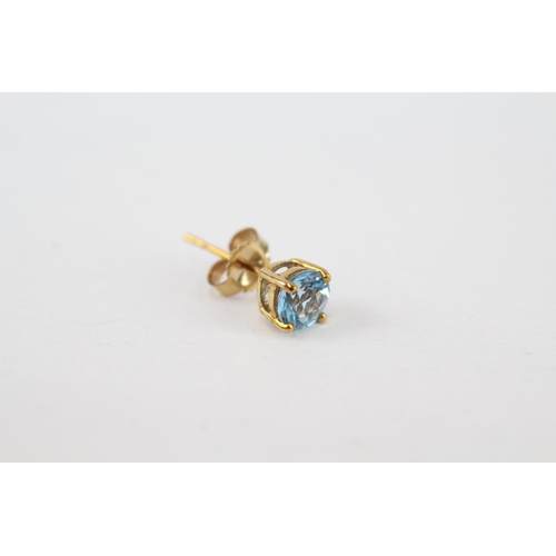 97 - 9ct gold blue topaz stud earrings with scroll backs (0.8g)