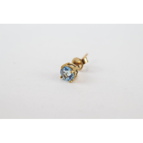 97 - 9ct gold blue topaz stud earrings with scroll backs (0.8g)