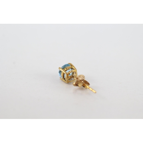 97 - 9ct gold blue topaz stud earrings with scroll backs (0.8g)