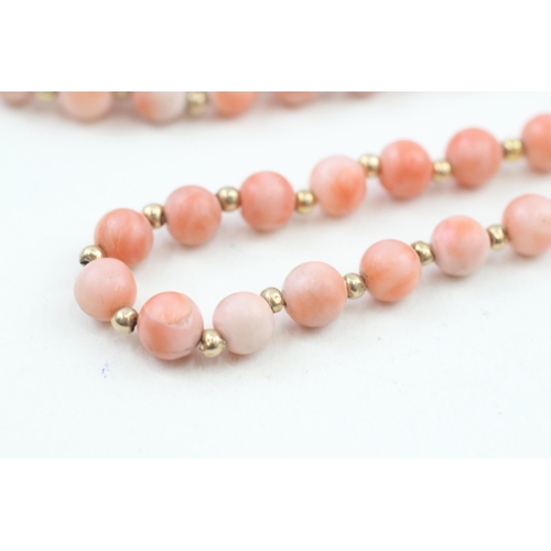 152 - 14ct gold clasped coral bead necklace with gold spacers (53.6g)