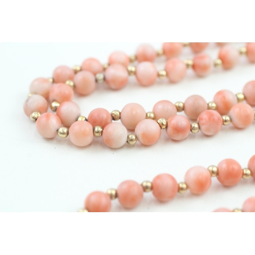 152 - 14ct gold clasped coral bead necklace with gold spacers (53.6g)