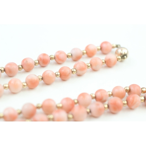 152 - 14ct gold clasped coral bead necklace with gold spacers (53.6g)