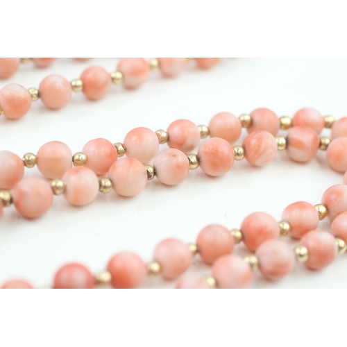 152 - 14ct gold clasped coral bead necklace with gold spacers (53.6g)