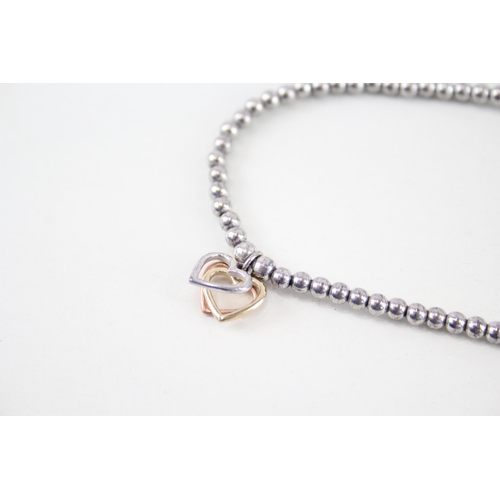 192 - 9ct Welsh gold heart shaped charm & silver bracelet by Clogau (4.5g)