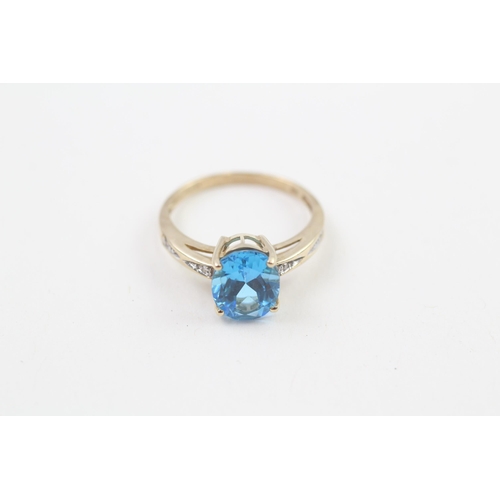 208 - 9ct gold oval cut blue topaz & diamond ring, claw set (2.5g) Size  N