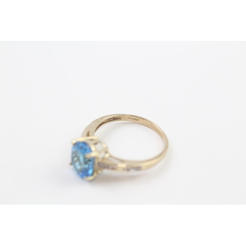 208 - 9ct gold oval cut blue topaz & diamond ring, claw set (2.5g) Size  N