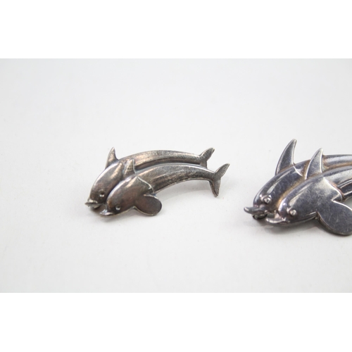 360 - Two silver dolphin brooches by Georg Jensen (8g)