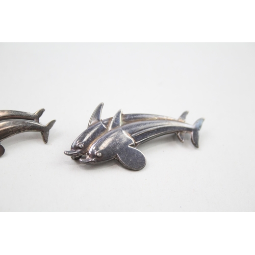 360 - Two silver dolphin brooches by Georg Jensen (8g)