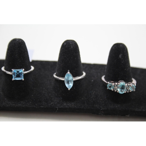 369 - A collection of silver gemstone rings including Blue Topaz (15g)