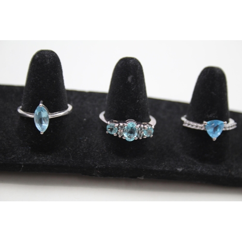 369 - A collection of silver gemstone rings including Blue Topaz (15g)