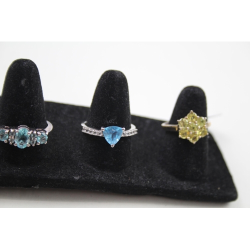 369 - A collection of silver gemstone rings including Blue Topaz (15g)