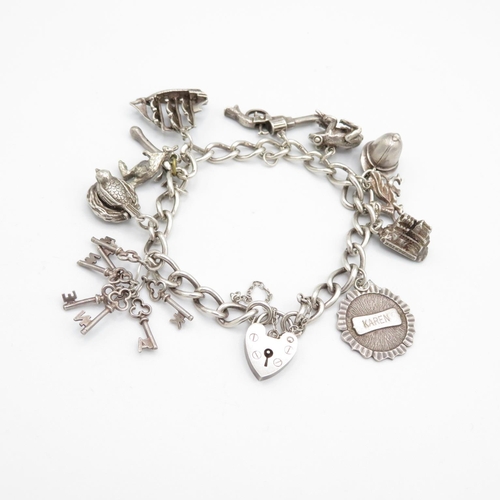 403 - HM silver charm bracelet with assorted charms, some articulated  48.2g