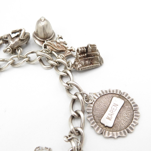 403 - HM silver charm bracelet with assorted charms, some articulated  48.2g