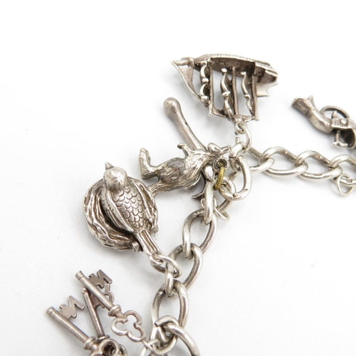 403 - HM silver charm bracelet with assorted charms, some articulated  48.2g