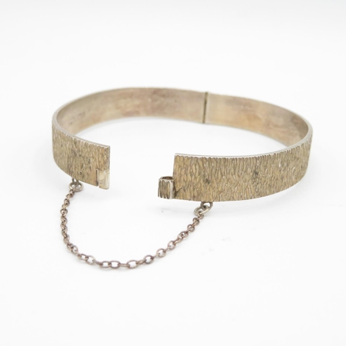 405 - HM silver bangle with safety chain and bark effect finish  20.8g