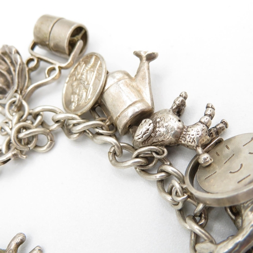 407 - HM silver charm bracelet with assorted charms, some articulated.  49.7g