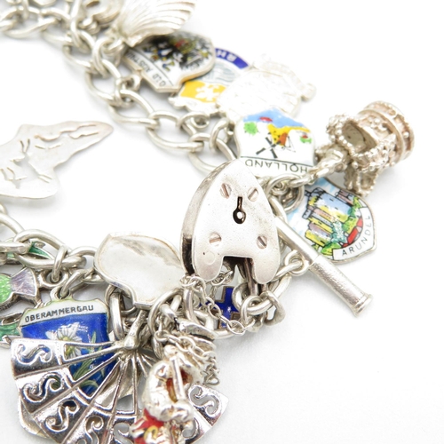 411 - HM silver charm bracelet with assorted charms, some articulated  60.8g