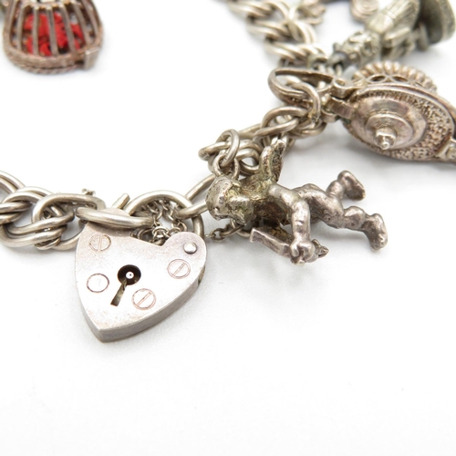 420 - HM silver charm bracelet with assorted charms, some articulated  43.6g