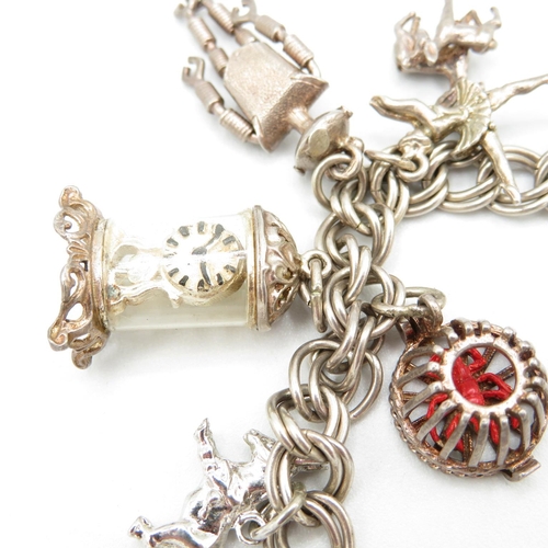 420 - HM silver charm bracelet with assorted charms, some articulated  43.6g