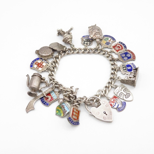 428 - HM silver charm bracelet with assorted charms including place names  52.8g