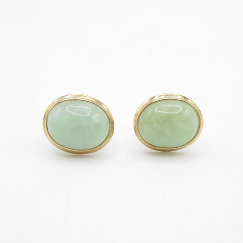 39 - 9ct gold cabochon cut jade stud earrings with scroll backs (1.4g)