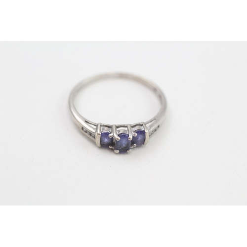 254 - 9ct white gold tanzanite three stone ring with diamond set shoulders 1.8g Size R