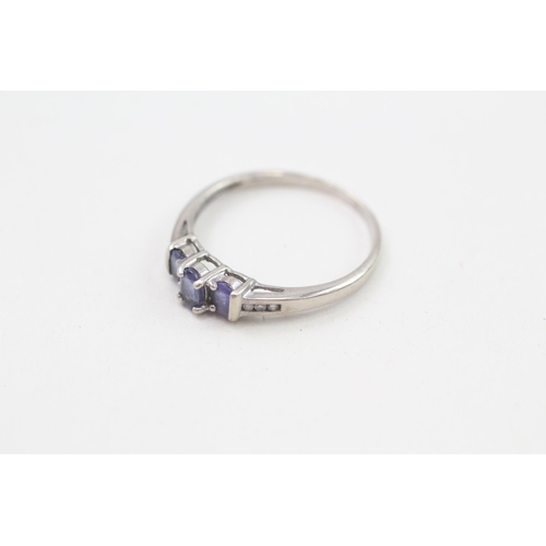 254 - 9ct white gold tanzanite three stone ring with diamond set shoulders 1.8g Size R