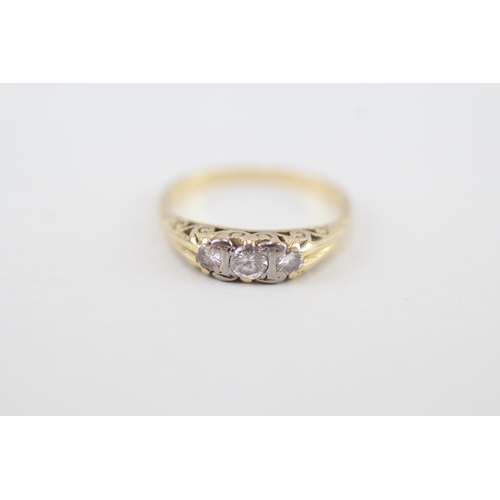 255 - 18ct gold vintage diamond three stone ring with scroll patterned gallery 3.1g Size L 1/2