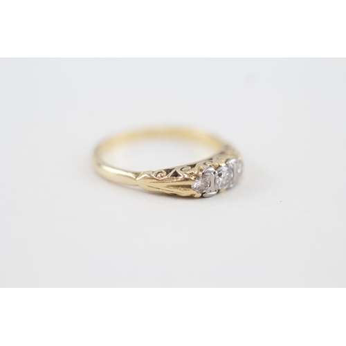 255 - 18ct gold vintage diamond three stone ring with scroll patterned gallery 3.1g Size L 1/2