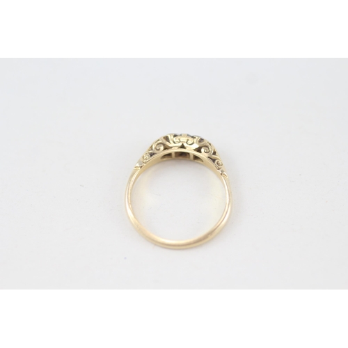 255 - 18ct gold vintage diamond three stone ring with scroll patterned gallery 3.1g Size L 1/2